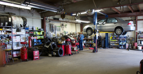 Picture of a mechanic  working on a car in an auto repair shop